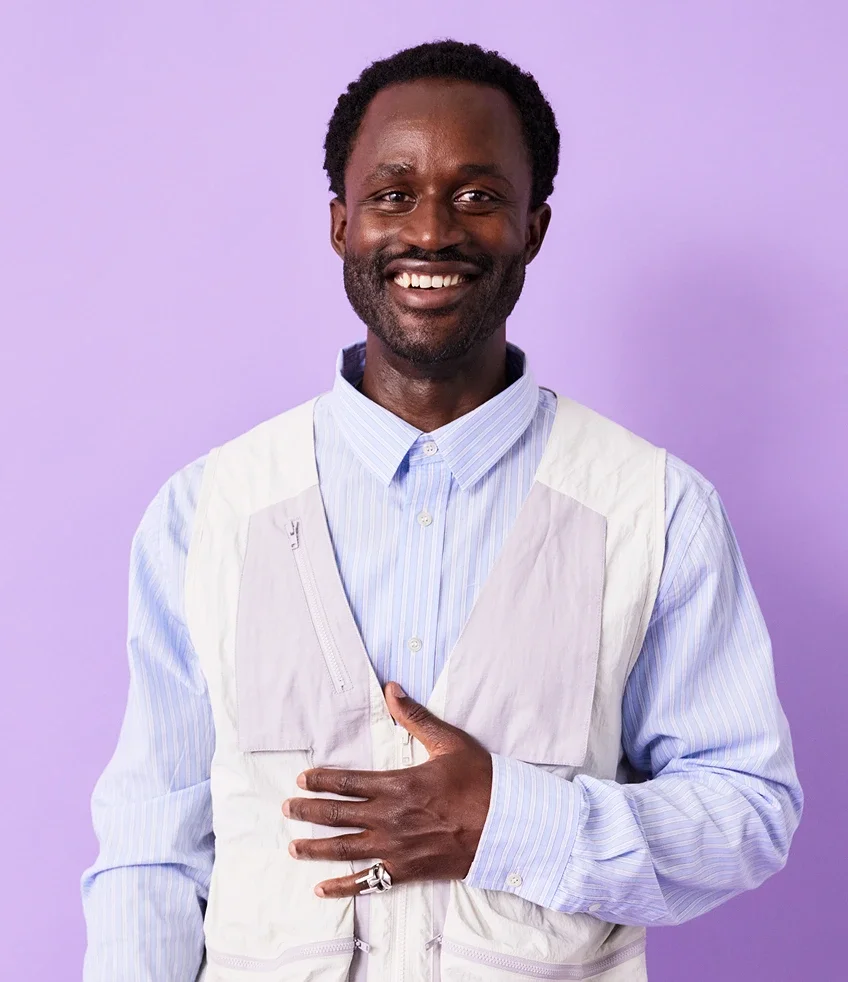 Portrait of man in front of purple backdrop